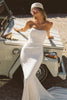 A woman wearing a strapless white mermaid style gown_XS_
