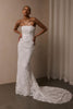 A woman wearing a strapless white lace wedding gown with a long train_XS_