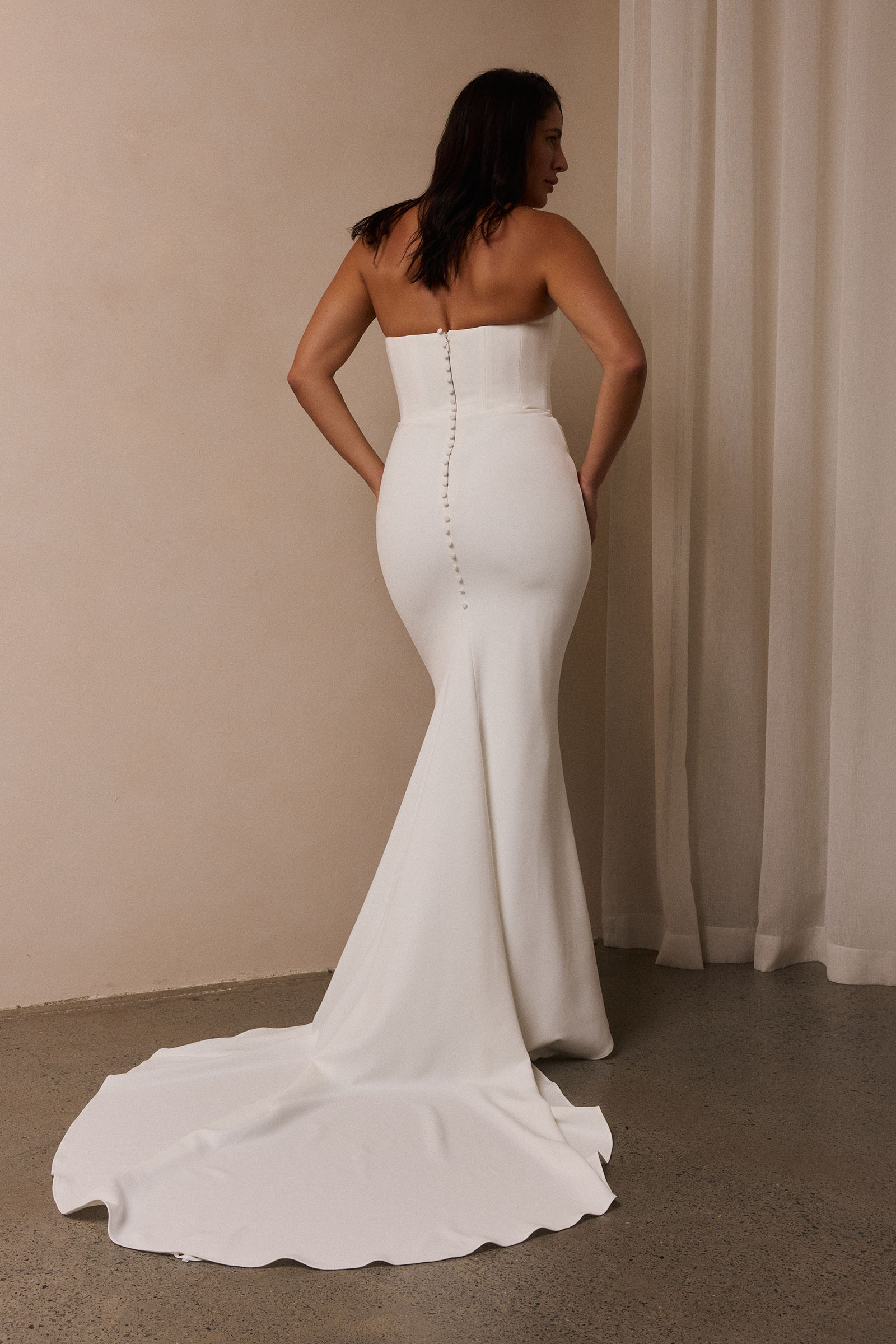 A woman wearing a strapless white mermaid style gown_L_