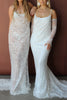 Two women wearing lace wedding dresses against a brown background