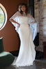 Woman in a white wedding dress with a chantilly lace cape