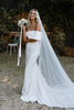 Woman standing in an off the shoulder crepe bridal gown
