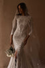 Model wearing the Pierlot gown and Pierlot Veil while holding white bouquet