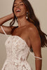 Woman wearing a white lace dress and pearl drop earrings