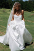 Woman in a white wedding dress with a long veil