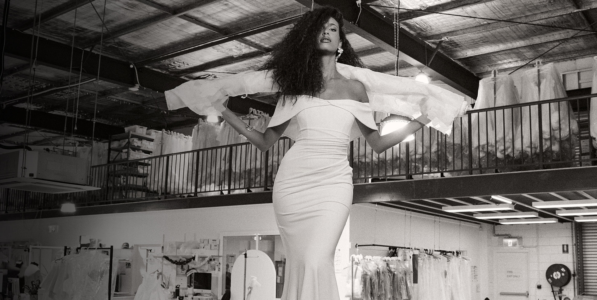 Woman wearing an off-the-shoulder wedding dress in a studio