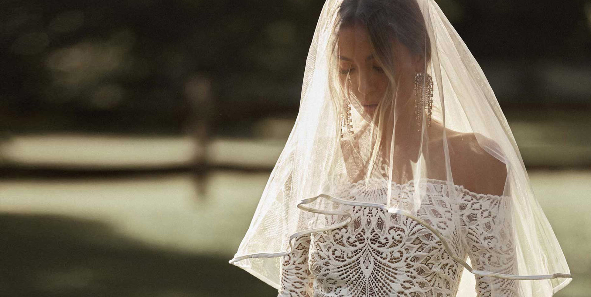 Woman wearing a lace wedding dress and veil